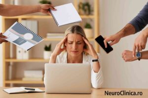 Femeie copleșită de sarcini la birou, semn al burnout-ului emoțional